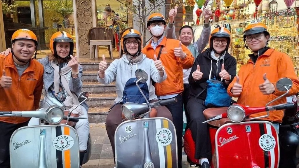 Join a Vespa night tour through the city